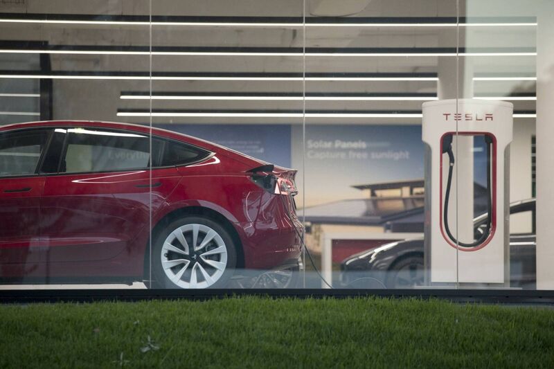 A Tesla electric vehicle charges at  a  showroom and service center. Photo: Bloomberg