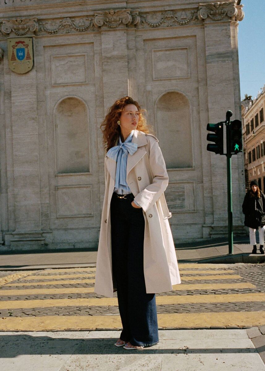 Trench coat, €179; lavallière-neck blouse, €79; gold buckle jeans, €79, strappy block heel leather sandals, €89, &amp; Other Stories