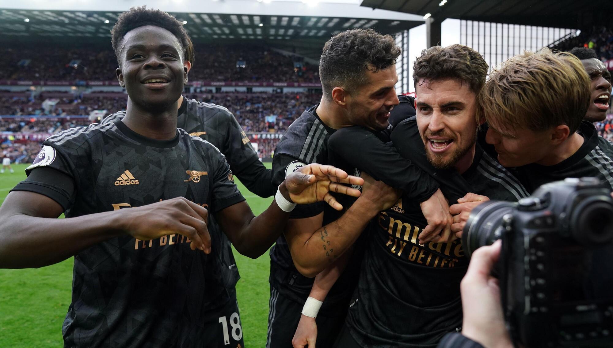 Arsenal score twice in injury time to beat Aston Villa and go top
