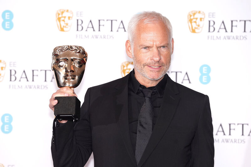 Martin McDonagh poses with the award for Original Screenplay for The Banshees of Inishein in the press room at the 76th British Academy Film Awards 