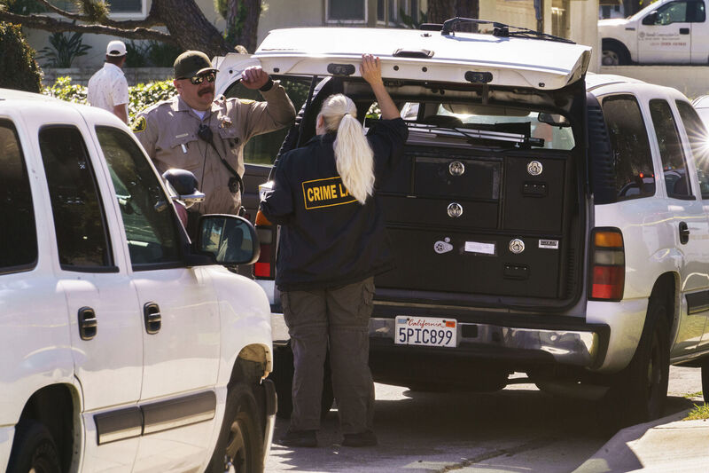 Authorities talk near the home of Bishop David O'Connell in Hacienda Heights, Calif. Picture: AP Photo/Damian Dovarganes Authorities talk near the home of Bishop David O'Connell in Hacienda Heights, Calif. Picture: AP Photo/Damian Dovarganes