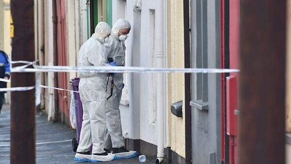 Members of the Garda forensic team examine the outside the house on the Bandon Road, Cork. Picture: Dan Linehan