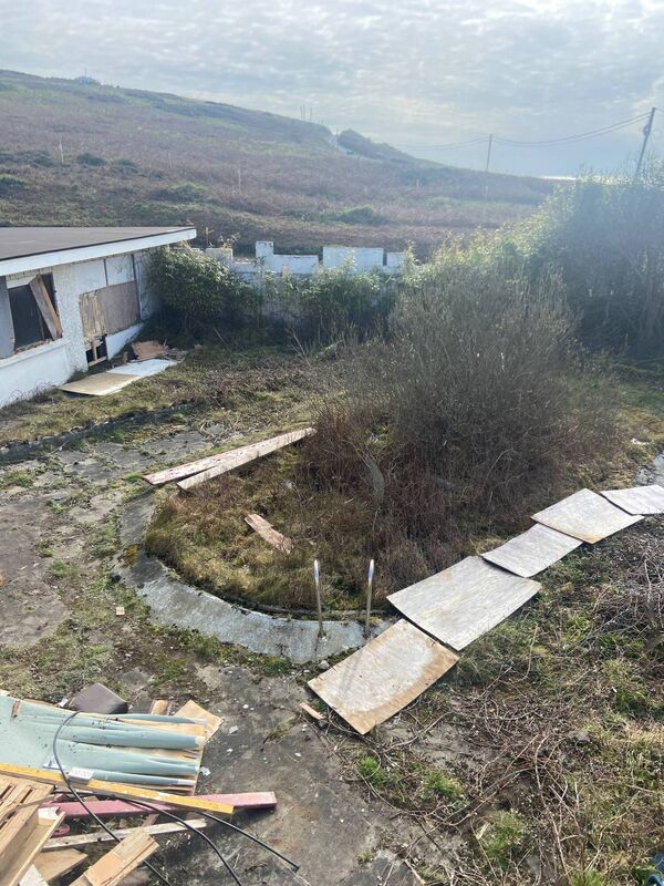 Work in hand: the filled-in swimming pool and boarded up main hotel block Work in hand: the filled-in swimming pool and boarded up main hotel block