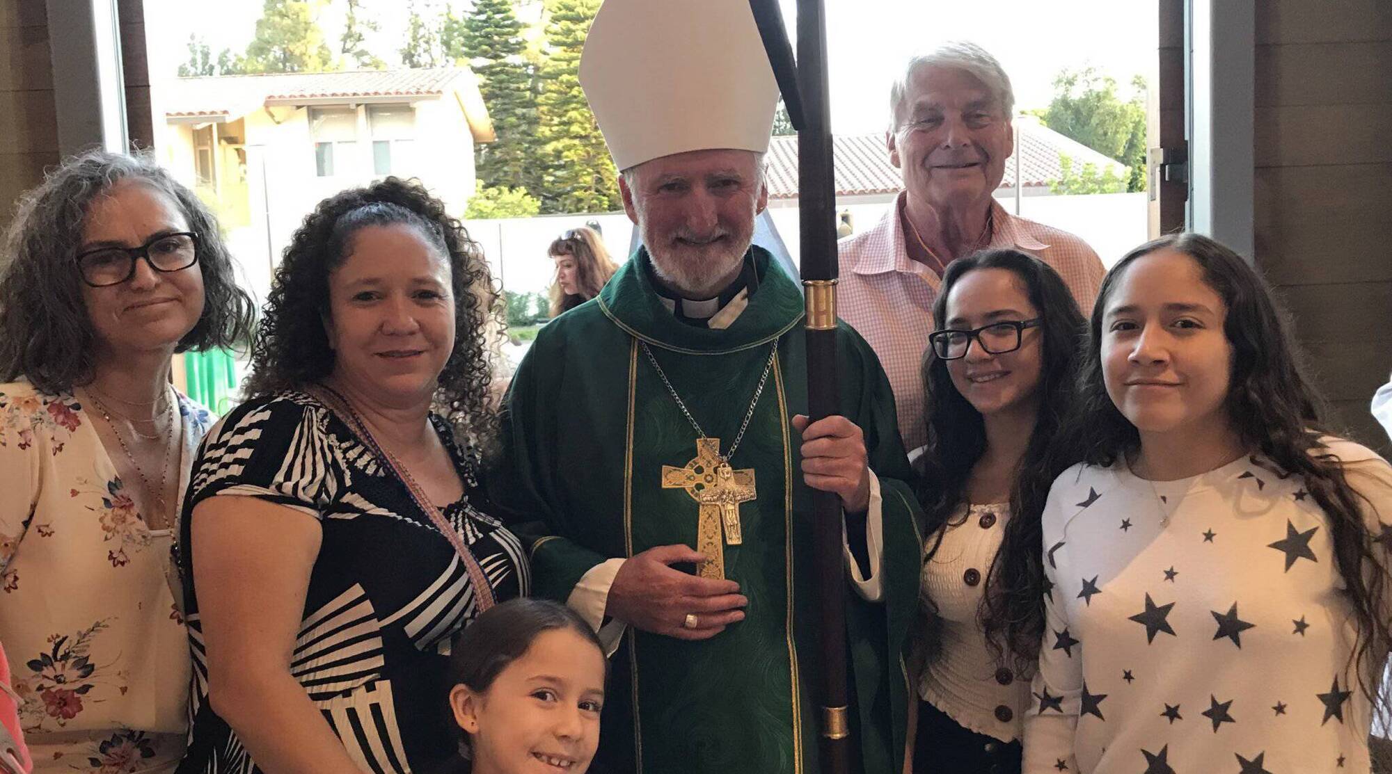 Bishop David O’Connell with Cleivi Jerez Arrendodo and her daughters, who he helped with rent after Cleivi’s husband Fernando was deported under the family separation policy brought in in the US in 2018.