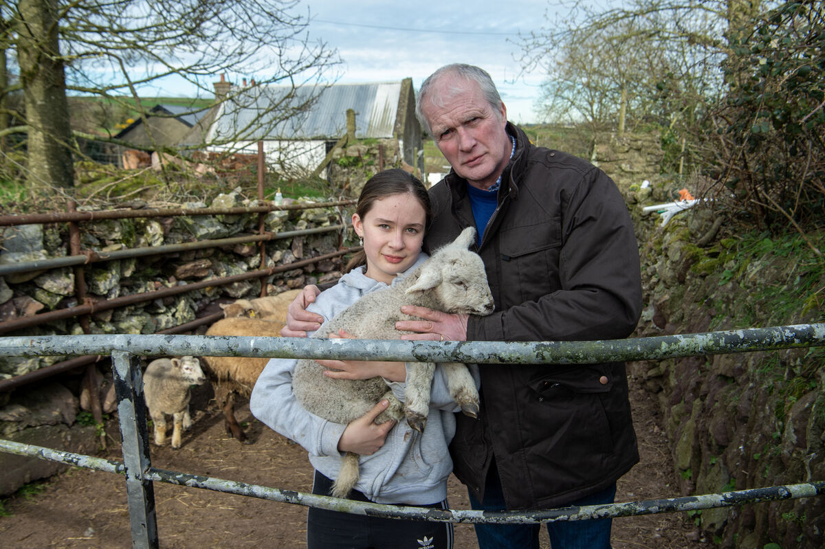  Dan Cronin with his daughter Ciara holding one of the lambs who was badly injured in a savage attack by dogs on their farm at Lower Killeens, Cork. Picture: Dan Linehan