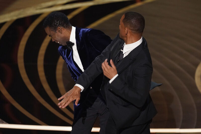 Will Smith, right, hits presenter Chris Rock on stage while presenting the award for best documentary feature at the Oscars on Sunday, March 27, 2022. Picture: AP Photo/Chris Pizzello, File Will Smith, right, hits presenter Chris Rock on stage while presenting the award for best documentary feature at the Oscars on Sunday, March 27, 2022. Picture: AP Photo/Chris Pizzello, File