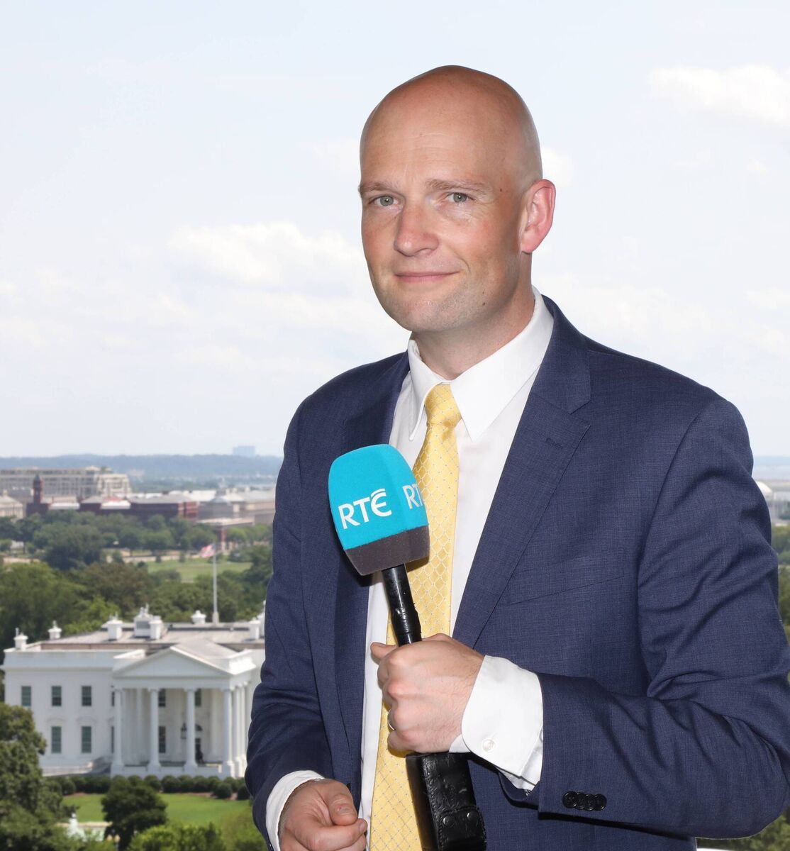 Former RTE Washington reporter Brian O'Donovan on 16th St. NW and in studio with White House beyond.  Former RTE Washington reporter Brian O'Donovan on 16th St. NW and in studio with White House beyond.