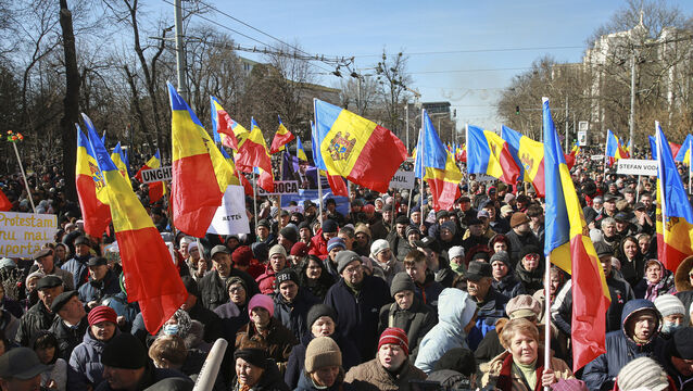 People wave flags during a protest initiated by the Movement for the People and members of Moldova’s Russia-friendly Shor Party, against the pro-Western government and low living standards, in Chisinau, Moldova (Aurel Obreja/AP)