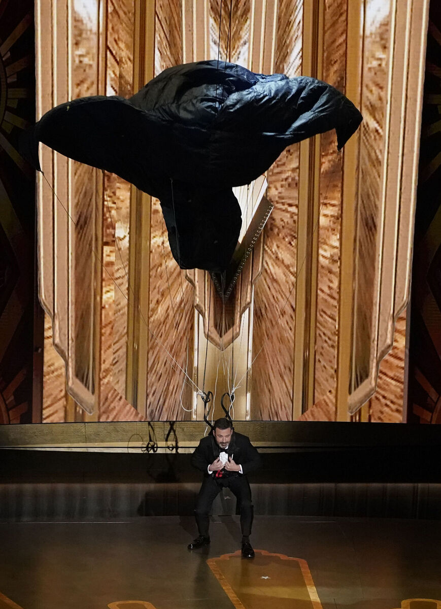 Host Jimmy Kimmel drops onto stage by parachute at the Oscars on Sunday, March 12, 2023, at the Dolby Theatre in Los Angeles. Pic: Chris Pizzello