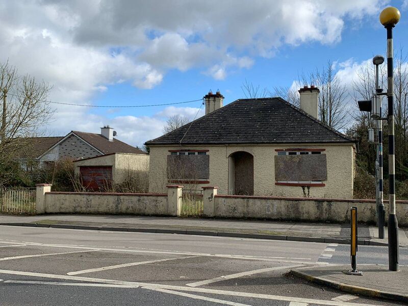 The former Kraus family home in Ballinasloe. The windows of the 1950s' style three-bedroom bungalow are all boarded up, the front garden completely overgrown. It is frozen in time.