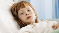 Thoughtful girl resting on bed in hospital