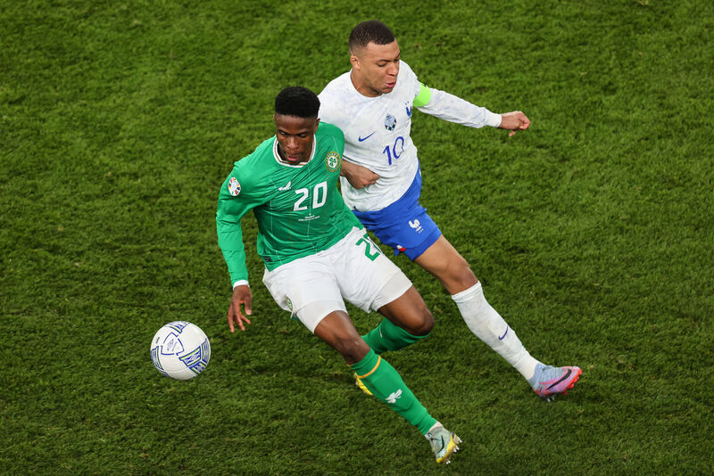 Chiedozie Ogbene takes on Kylian Mbappé. Picture: INPHO/Ben Brady
