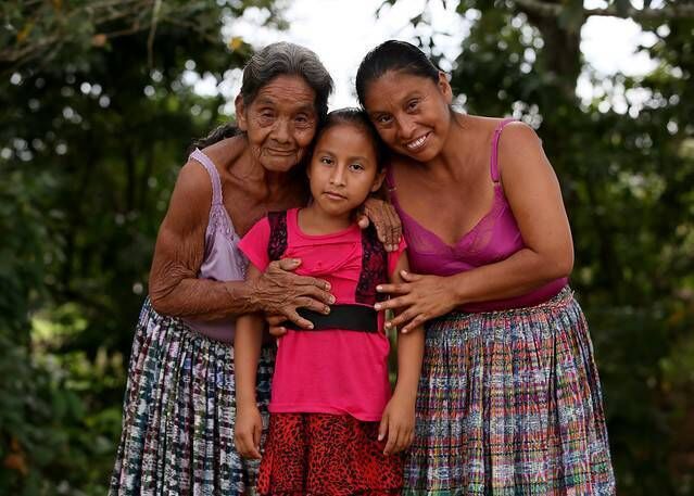 María Angelica Cuc Teyul with her mother Adela and grandmother María outside their home in Parana in the Polochic Valley in northern Guatemala. Picture: Mark Stedman María Angelica Cuc Teyul with her mother Adela and grandmother María outside their home in Parana in the Polochic Valley in northern Guatemala. Picture: Mark Stedman
