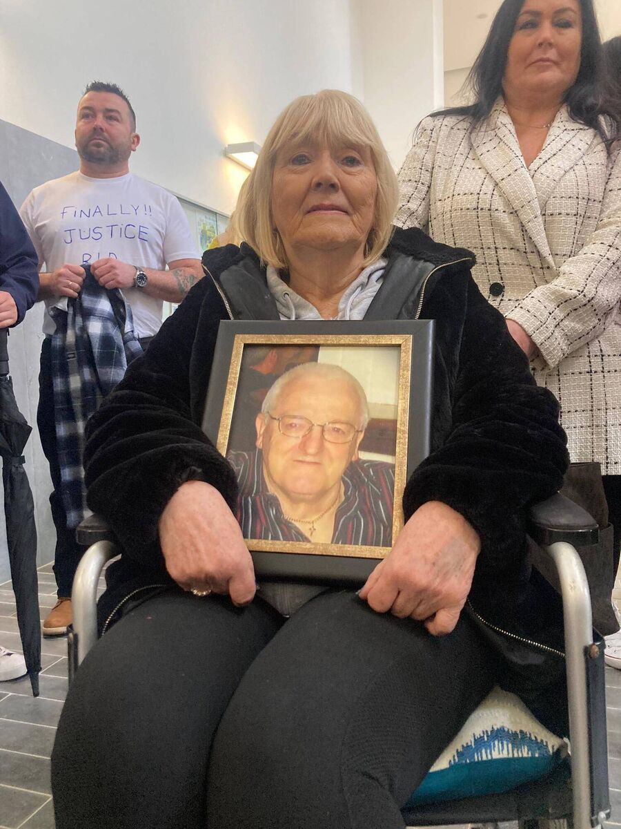 Mike Daly Snr's widow Mary, holding a framed photograph of her husband.