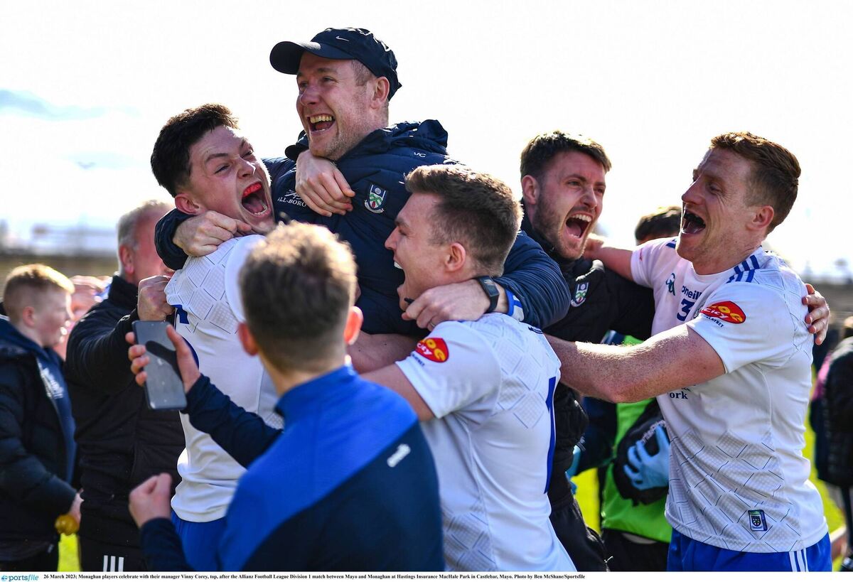 THE GREAT SURVIVORS: Monaghan players celebrate with their manager Vinny Corey. Pic: Ben McShane/Sportsfile