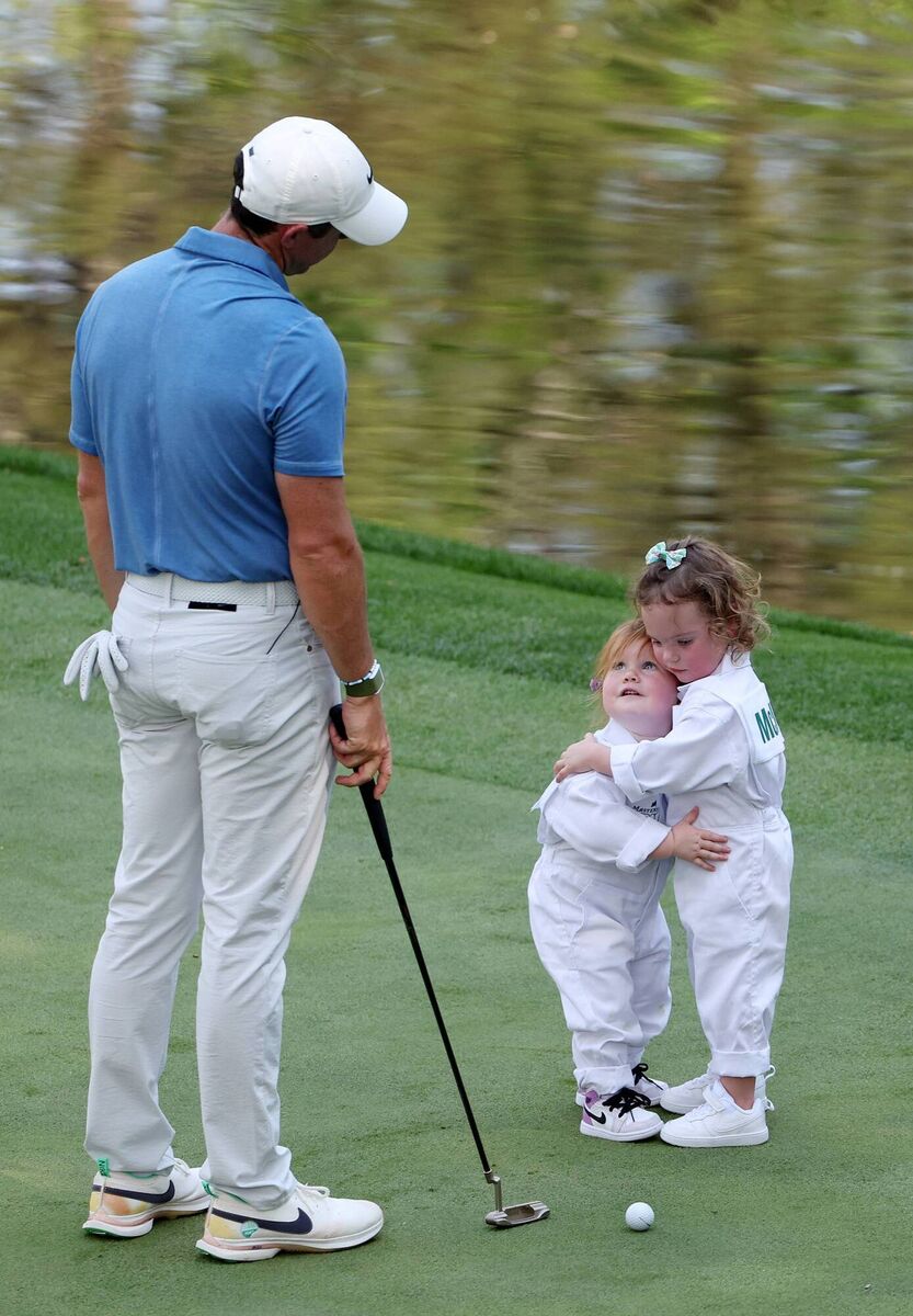 Rory McIlroy looks on as Ivy Lowry hugs Poppy McIlroy on the ninth green during the Par 3 contest prior to the 2023 Masters Tournament at Augusta National Golf Club on April 05, 2023 in Augusta, Georgia. Picture: Christian Petersen/Getty Images