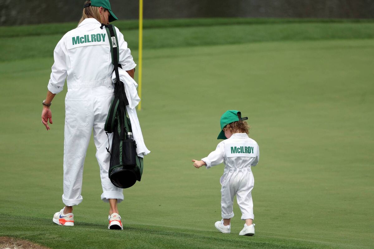 Erica Stoll walks on the first green with their daughter Poppy McIlroy on the first hole during the Par 3 contest prior to the 2023 Masters Tournament at Augusta National Golf Club on April 5. Picture: Patrick Smith/Getty Images