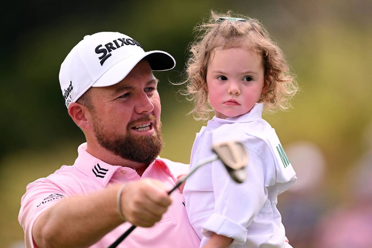 Shane Lowry looks on with Rory McIlroy's daughter Poppy McIlroy on the first hole during the Par 3 contest prior to the 2023 Masters Tournament at Augusta National Golf Club  in Augusta, Georgia. Piture: Ross Kinnaird/Getty Images)