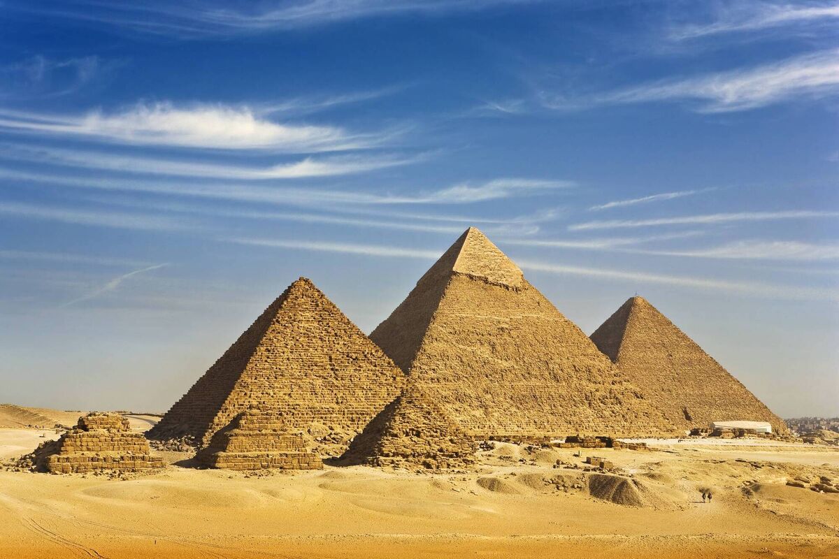 A view of the Pyramids from the Giza Plateau - there is three pyramids popularly known as Queens' Pyramids on front side; next in order from left: the Pyramid of Menkaure/Mykerinos, Khafre/Chephren, and Chufu/Cheops - known as the Great Pyramid.