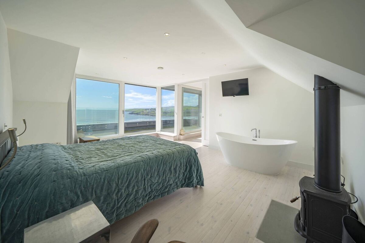 Tearmann's main bedroom, with stove and free-standing bath