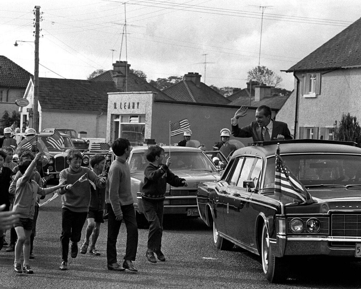 Then US president Richard Nixon waving to flag-waving children as his motorcade drives through Timahoe, Co Kildare, on October 5, 1970. File picture: Popperfoto/Getty