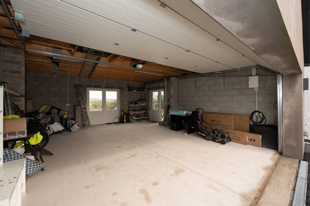 Spacious lofted garage is set up for conversion to upstairs two-bed unit