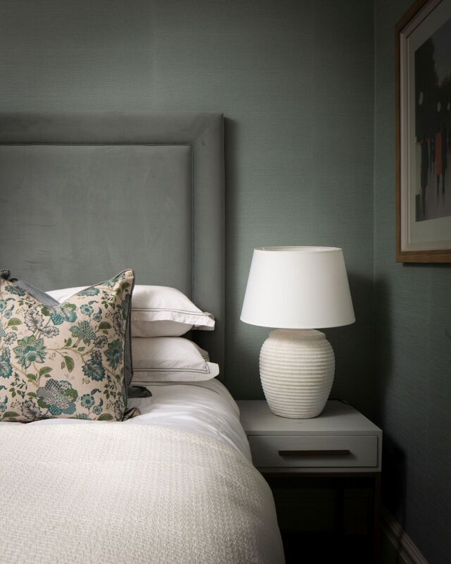 A darker green palette features in the guest bedroom, including a textured wallpaper with a fabric-like quality by Lewis & Wood. A darker green palette features in the guest bedroom, including a textured wallpaper with a fabric-like quality by Lewis & Wood.
