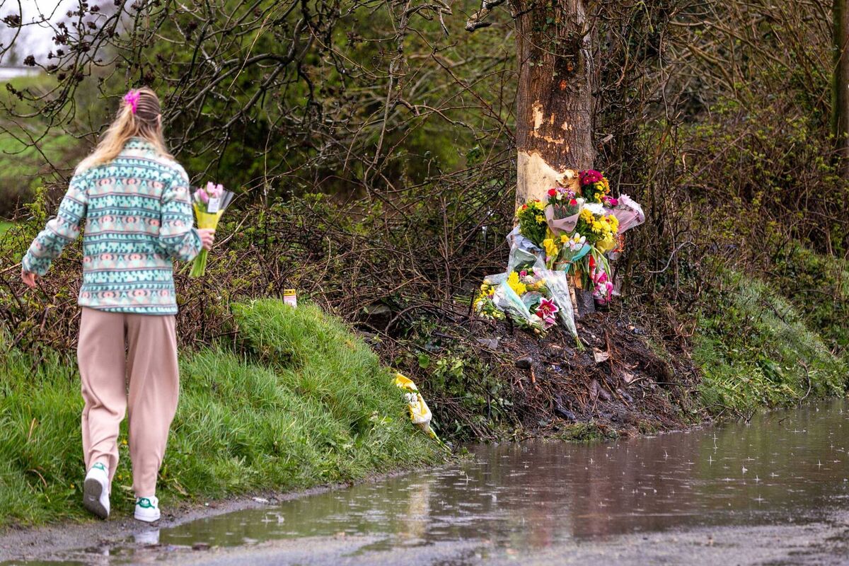 A member of the local community placing more flowers among the bouquets left at the scene of the accident on the L6127 in Headford Co Galway, where teenagers Kirsty and Lukas lost their lives. A member of the local community placing more flowers among the bouquets left at the scene of the accident on the L6127 in Headford Co Galway, where teenagers Kirsty and Lukas lost their lives.