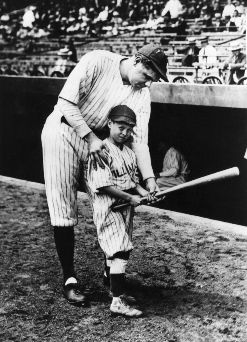 'BABE': George Herman Ruth, showing a youngster how to hold a basesball bat in Yankee Stadium. 