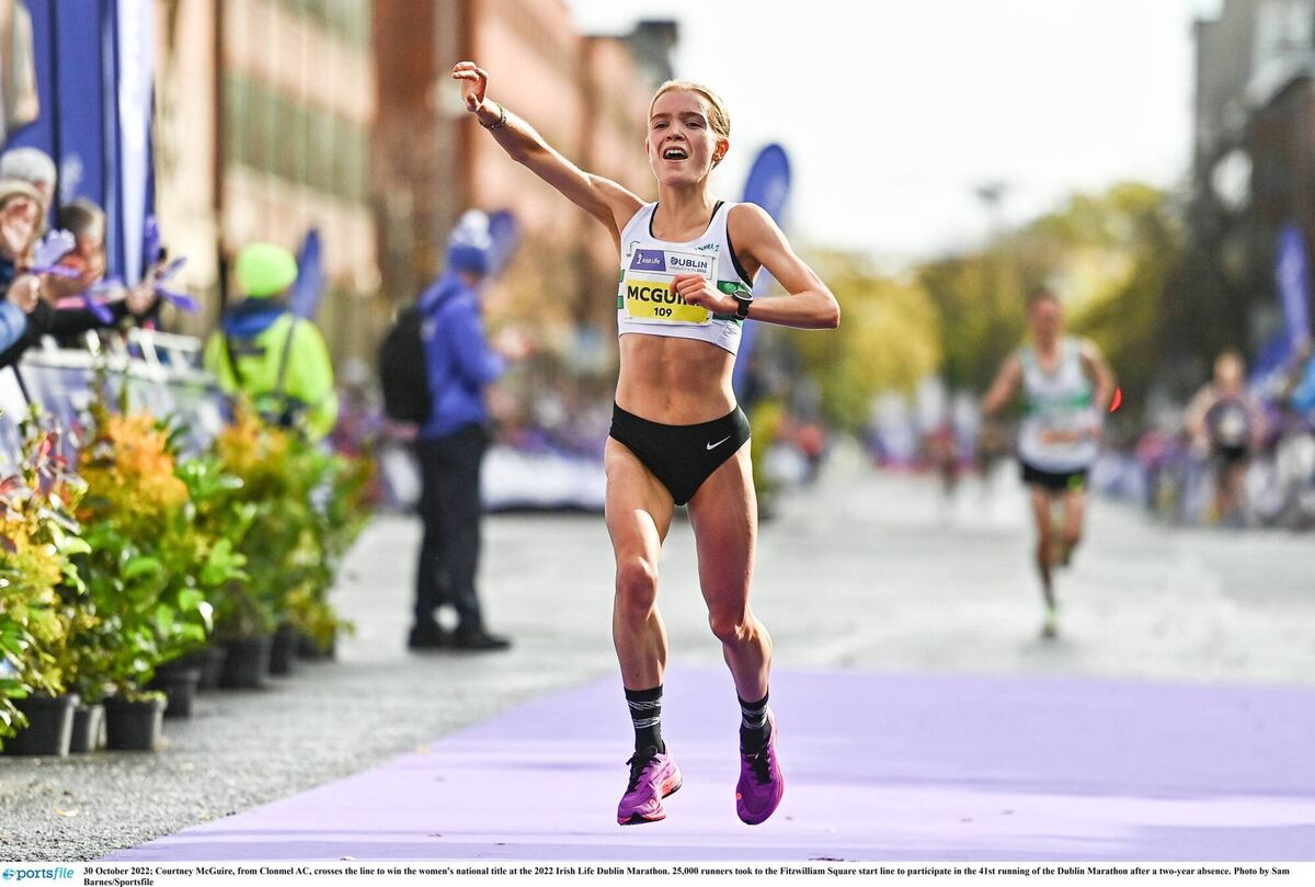 Courtney McGuire, from Clonmel AC, crosses the line to win the women's national title at the 2022 Irish Life Dublin Marathon. Pic: Sam Barnes/Sportsfile 