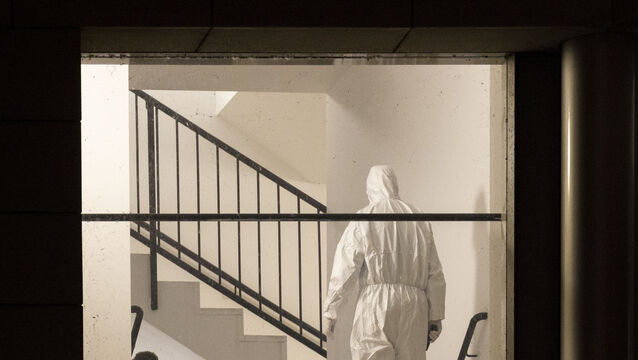 A member of the forensics team inspects the gym (dpa via AP)
