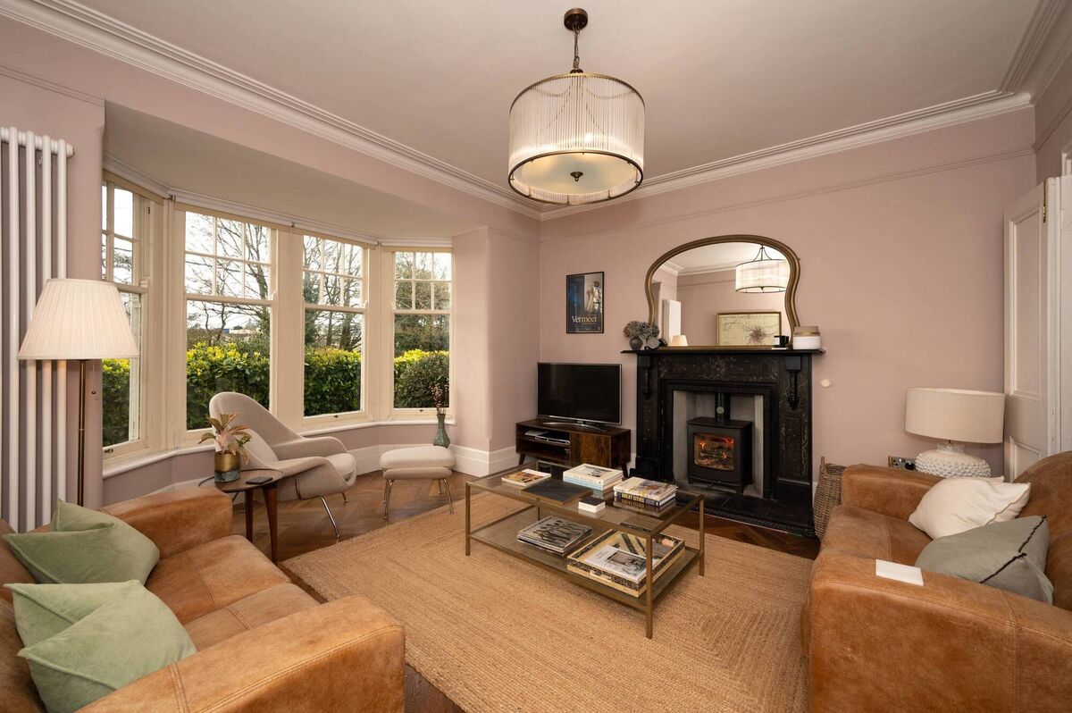 Main living area with bay window, new oak parquet floor and stove