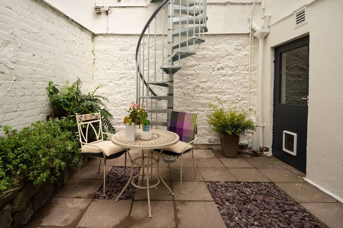 Courtyard to the rear with access to raised gardens