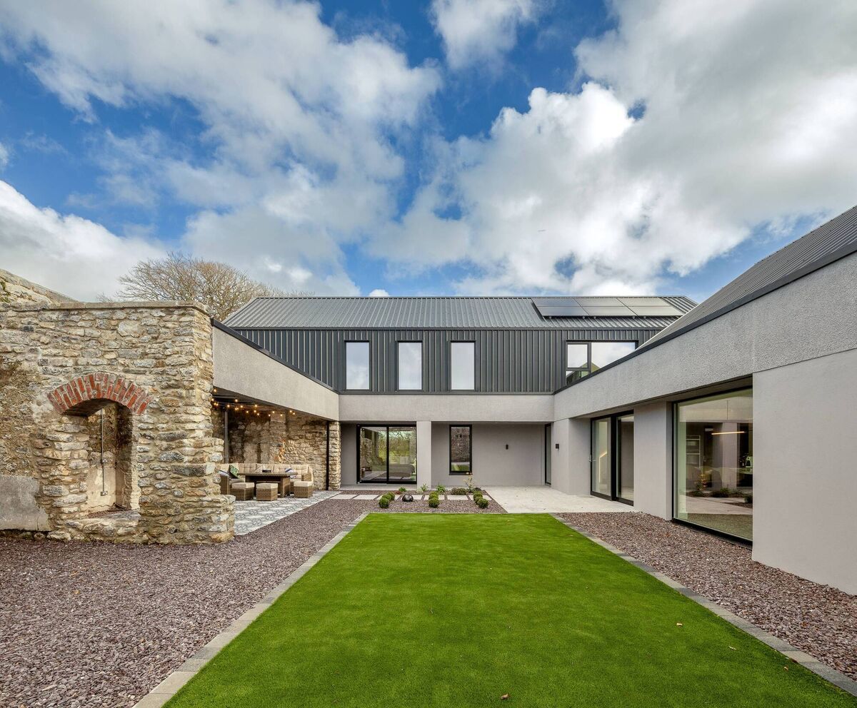 The old stone walls bring the drama to the modern design of Walled Garden House. 