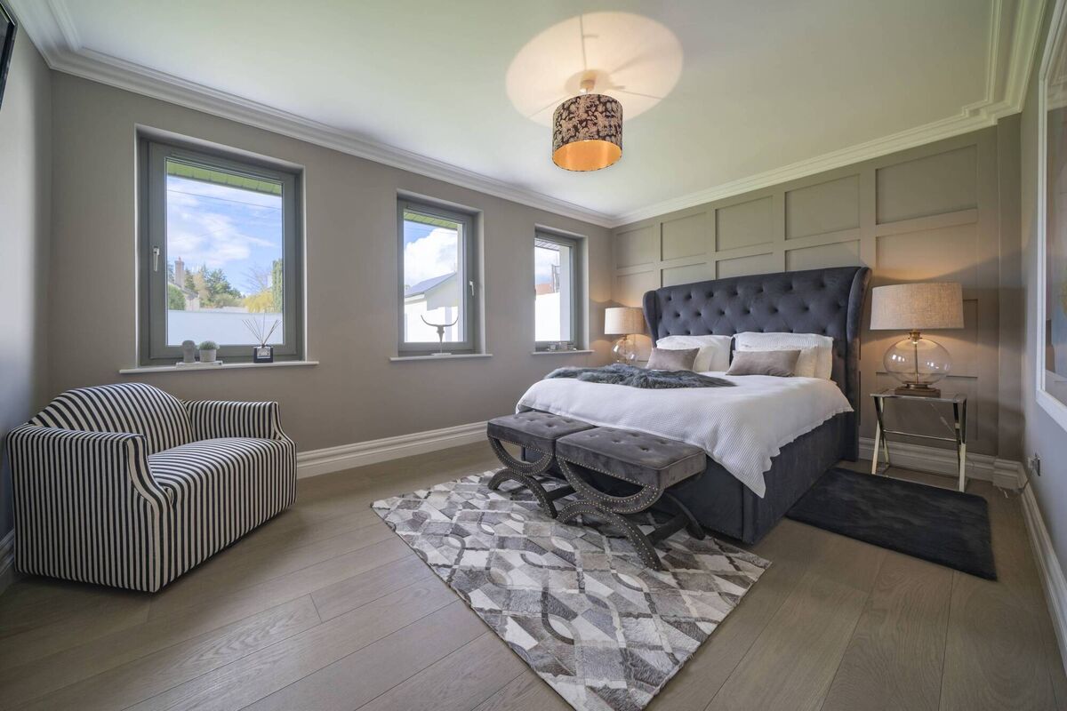 Bedroom with paneled back wall