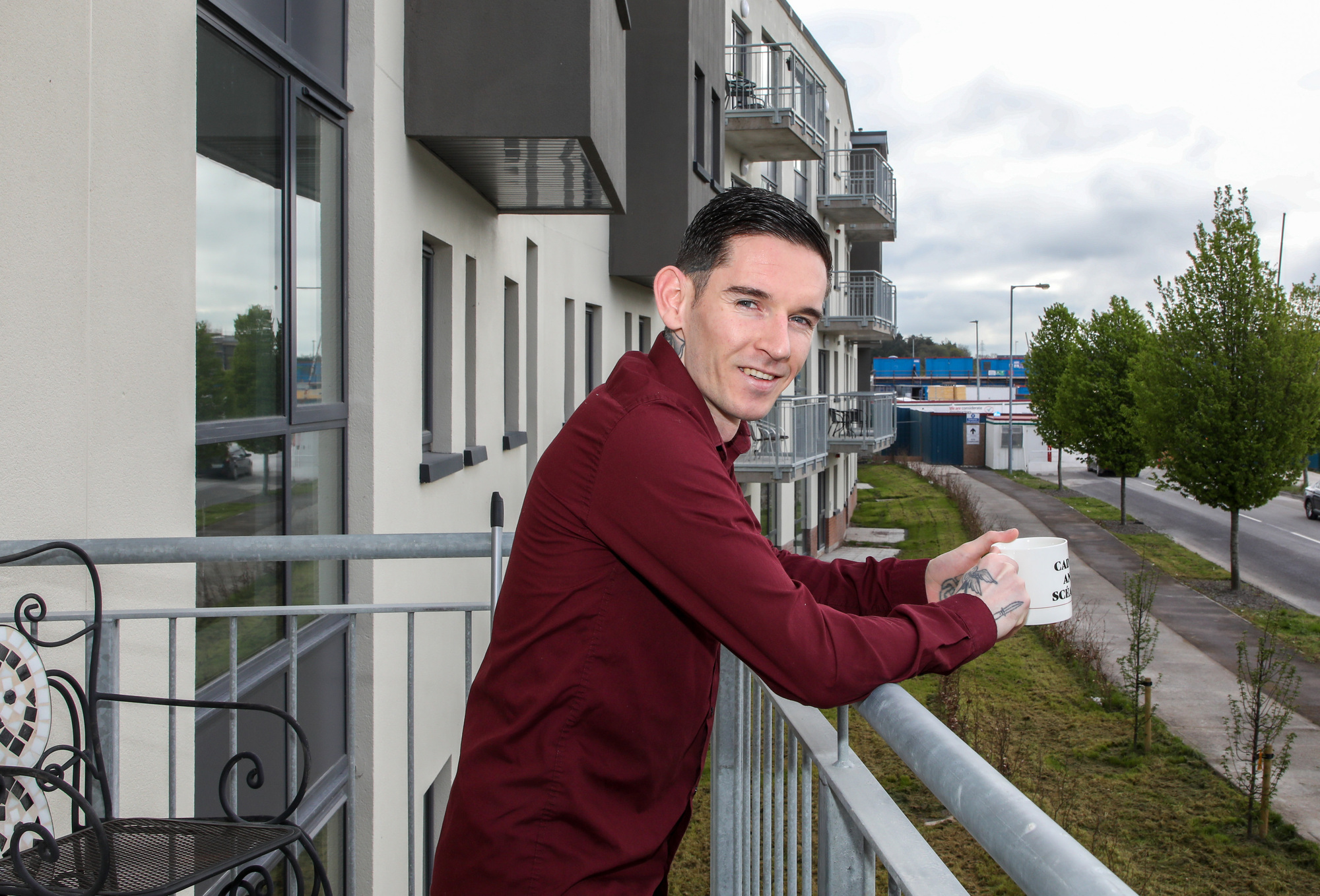 Jonathan O'Mahony on the balcony of his new apartment: 'To have a home now is one of the best feelings I’ve ever had — to have a place that’s safe and secure.' Picture David Creedon