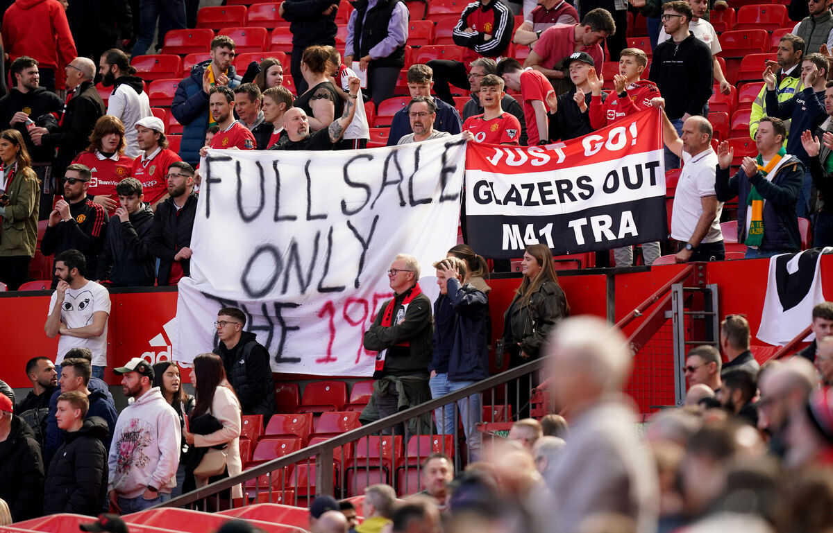 Manchester United fans with Glazers Out banners in the stands during the Premier League match at Old Trafford, Manchester. 