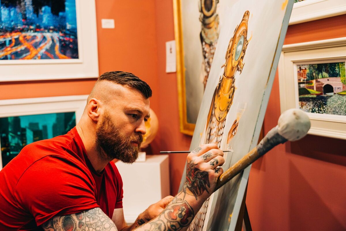  Artist Ed Williamson creating an artwork on the Oriel Gallery's stand at the Ideal Home Show.