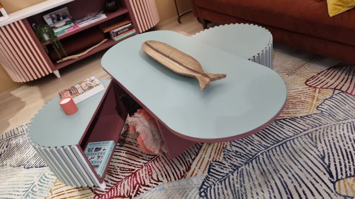  Interior and furniture designer Monica Daly of MD Designs shows her Clam coffee table which expands to increase its surface area and provide additional seating.