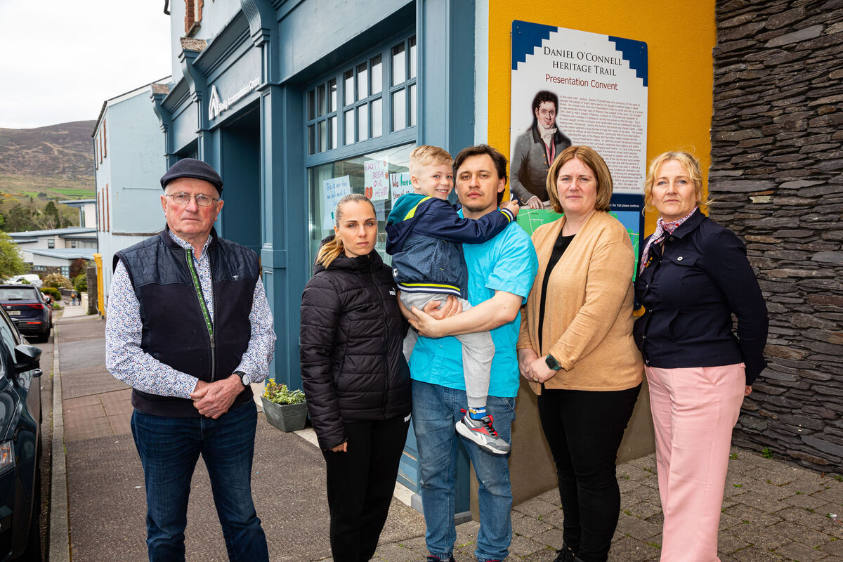 Fr Patsy Lynch; Geraldine O'Sullivan, Scoil Saidhbhín; and Treasa Cronin, principal at Scoil Saidhbhín with Yuliia Kotora, Tymofii Katunin, and Vlad Katunin, one of the families who were to be moved from Cahirciveen. Picture: Alan Landers