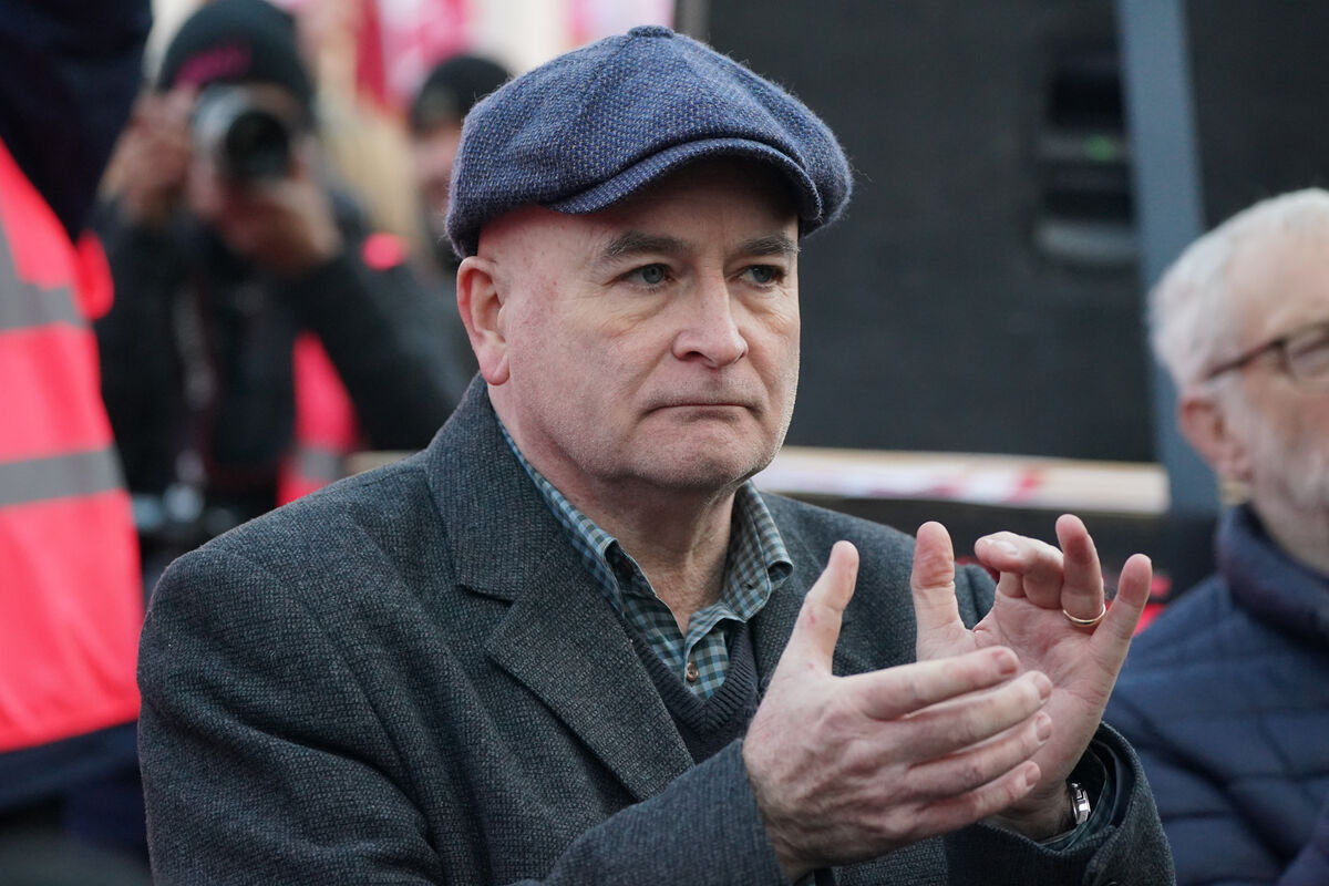 Mick Lynch, general secretary of the Rail, Maritime and Transport union (RMT) joins members of the Communication Workers Union (CWU) during a rally in Parliament Square, London