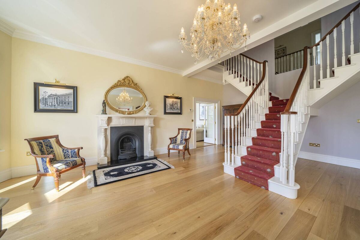 Fireplace in the enlarged hall with gleaming refinished oak floor Fireplace in the enlarged hall with gleaming refinished oak floor