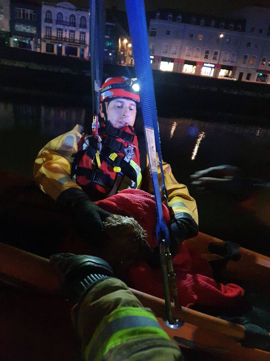 The dog was hoisted back over the wall with a fireman. Picture: Cork City Fire Brigade via Twitter The dog was hoisted back over the wall with a fireman. Picture: Cork City Fire Brigade via TwitterÂ