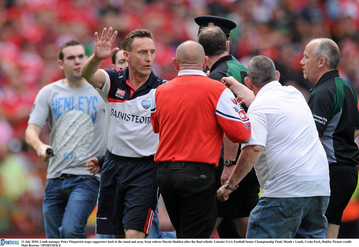 REF JUSTICE: Louth manager Peter Fitzpatrick urges supporters back to the stand and away from referee Martin Sludden in 2010. Picture:Matt Browne / SPORTSFILE