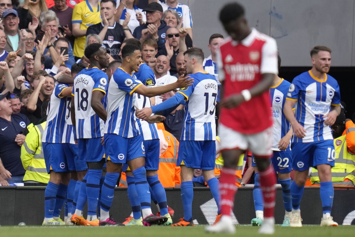 Brighton's Pervis Estupinan, covered by his teammates, celebrates after scoring his side's third goal during the English Premier League soccer match between Arsenal and Brighton and Hove Albion at Emirates stadium in London, Sunday, May 14, 2023. (AP Photo/Kirsty Wigglesworth) Brighton's Pervis Estupinan, covered by his teammates, celebrates after scoring his side's third goal during the English Premier League soccer match between Arsenal and Brighton and Hove Albion at Emirates stadium in London, Sunday, May 14, 2023. (AP Photo/Kirsty Wigglesworth)