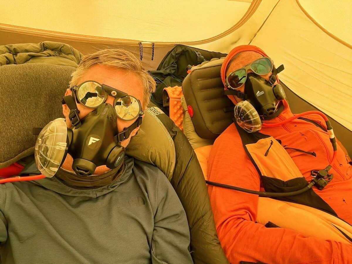 Johnny Ward and friend with oxygen masks during final Everest summit Johnny Ward and friend with oxygen masks during final Everest summit