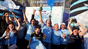 <p>BLUE MOON: Manchester City fans celebrate outside of the Etihad Stadium after winning the Premier League following the outcome of the Nottingham Forest v Arsenal match. Pic: Martin Rickett/PA Wire.</p>