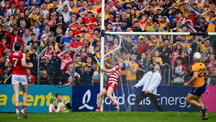 <p>EYES UP: An umpire and the Cork goalkeeper Ger Collins watch Diarmuid Ryan's shot go over the bar for what proves to be be the winning point during the Munster SHC round 4 match at Cusack Park in Ennis. Pic: Ray McManus/Sportsfile</p>