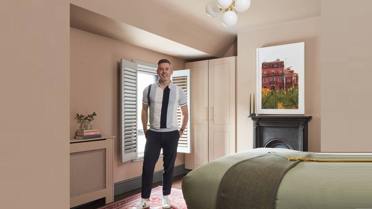 Darran Heaney in the master bedroom of his Phibsborough home, which underwent a dramatic makeover using the Dulux Heritage range.