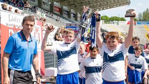 <p class="contextmenu internal_Caption"> CHAMPIONS: Tom Kenny pictured presenting joint team captains Mikey Stokes and Sean Crean of St Marys on the Hill with the Cup. Picture: Howard Crowdy</p>